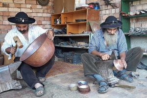 Gypsy father and sun coppersmith craftsmen, Transylvania